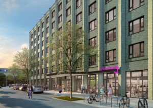 Außenansicht des Moxy Köln Mülheim mit grüner Klinkerfassade