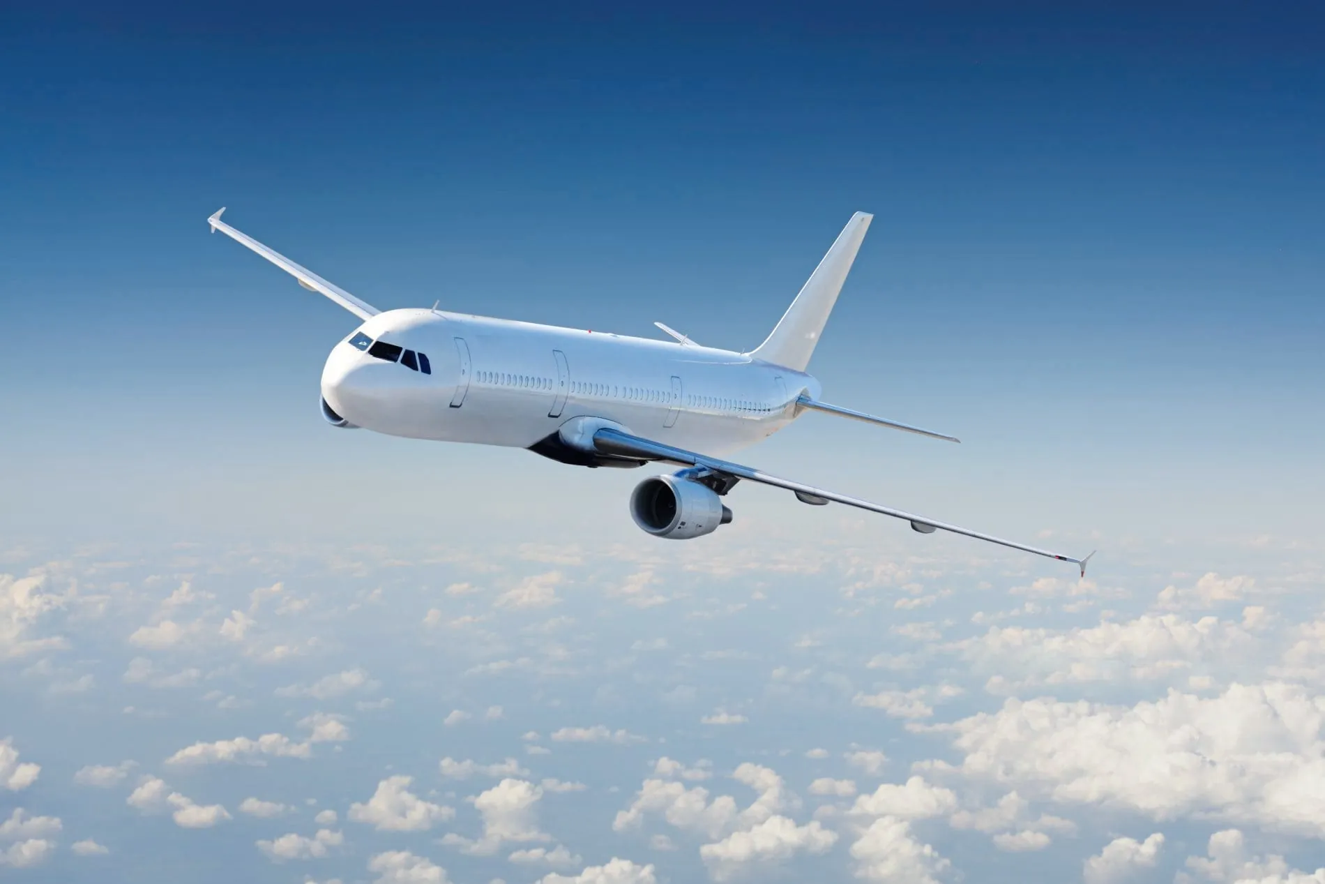 Airplane in the sky, over the cloudy sky