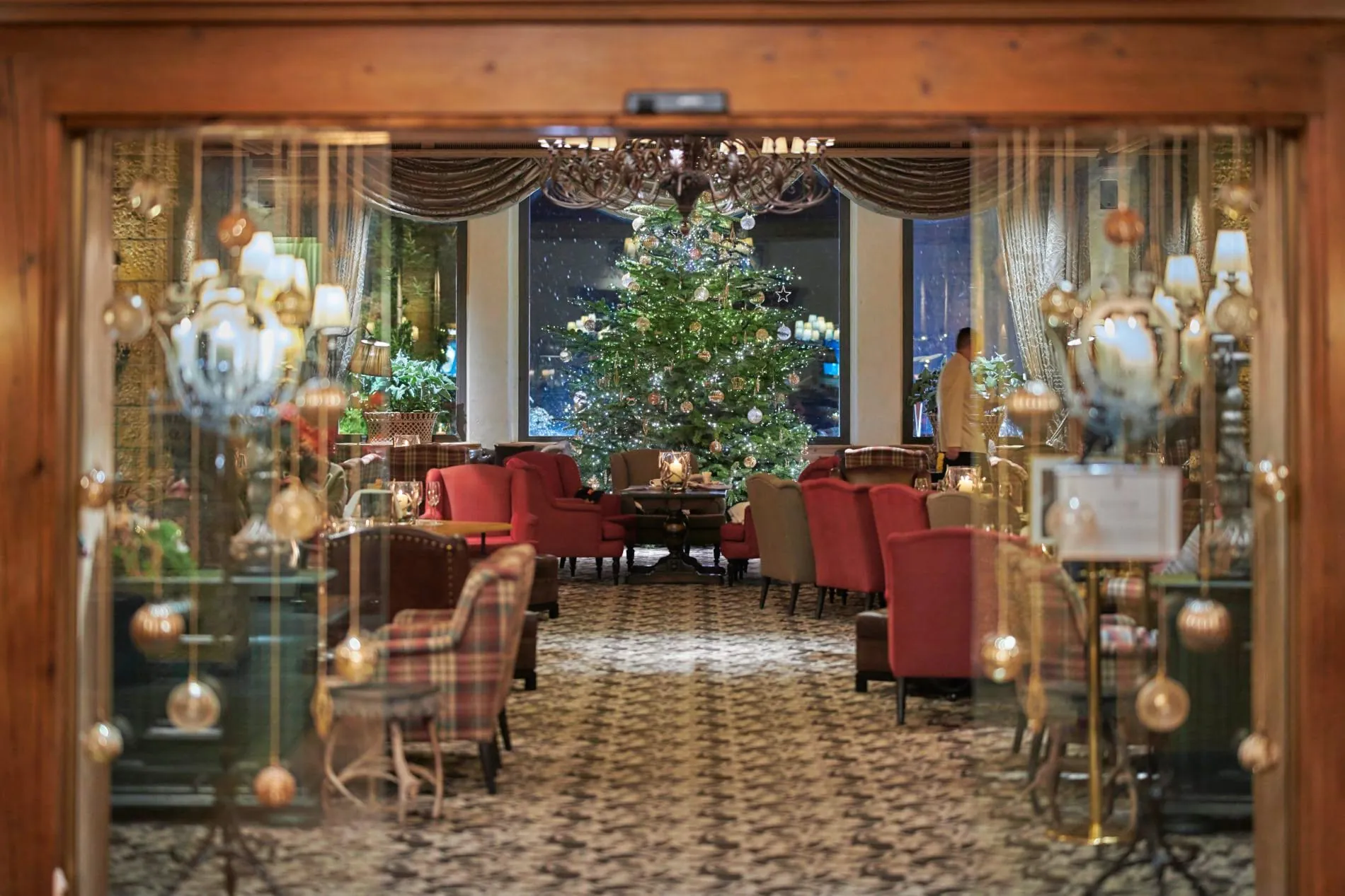 Der stilvoll geschmückte Weihnachtsbaum verbreitet festliche Stimmung in der Lobby Bar des Gstaad Palace.