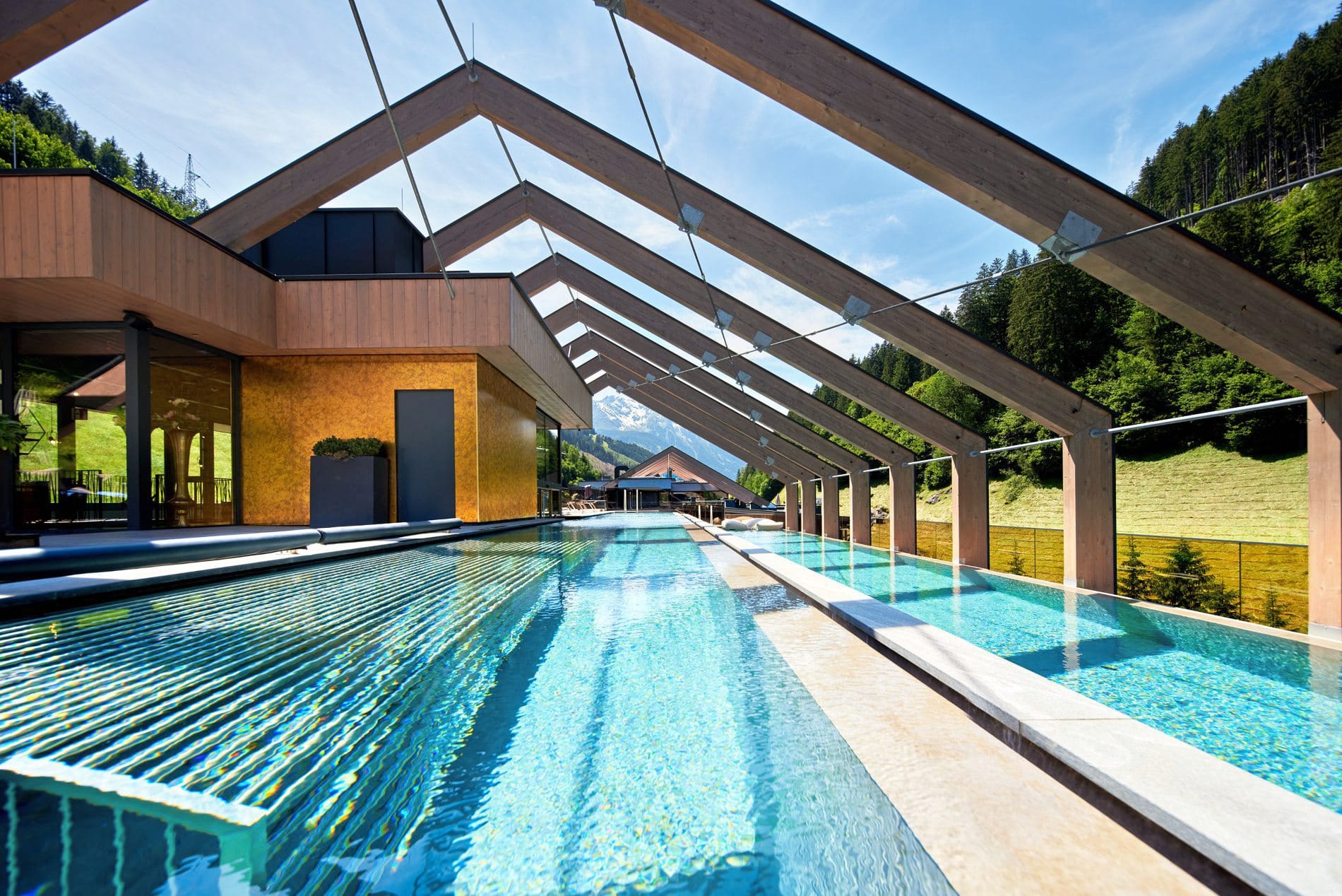 Der Skypool im Sky Spa des Zillergrund Rock Luxury Mountain Resorts erstreckt sich über zwei Ebenen mit jeweils 50 Metern Schwimmlänge und Blick auf das umliegende Bergpanorama. Zur Anlage gehören Hängeliegen und Ruhezonen auf der Alpin-Rock-Terrasse.