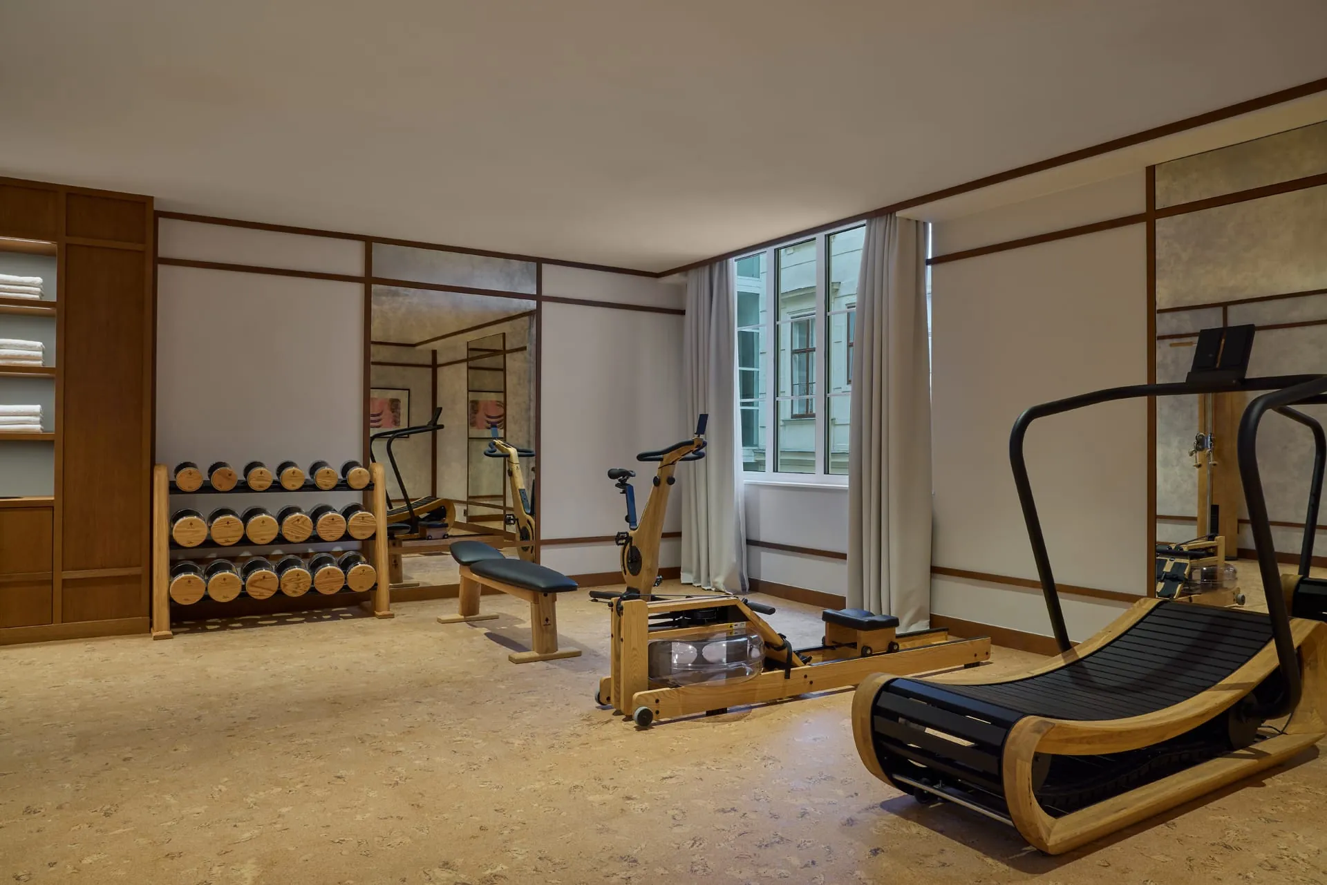 Das rund Fitnessstudio setzt auf hochwertige Geräte aus Holz – darunter ein Rudergerät, ein Laufband und ein Ergometer.