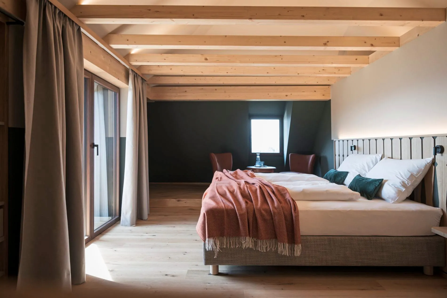 Holzbalken und dunkelgrüne Wände verleihen der Duplex-Suite einen alpinen Charakter.