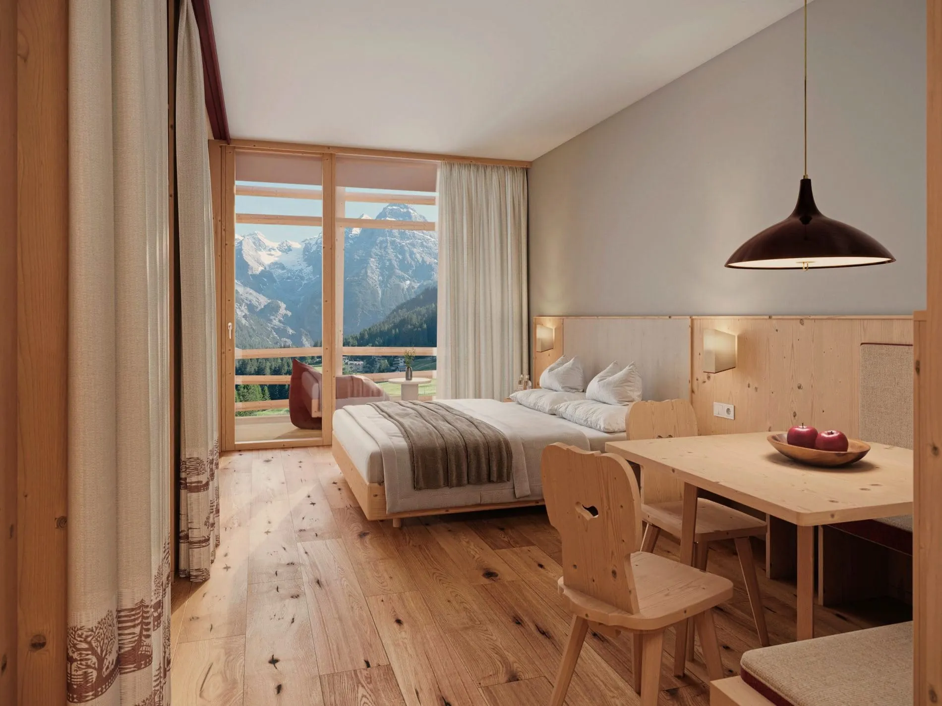 Die Suiten im „Nest" des Bella Vista setzen auf helles Fichtenholz, warmes Licht und bodentiefe Fenster mit Blick auf die Bergwelt.