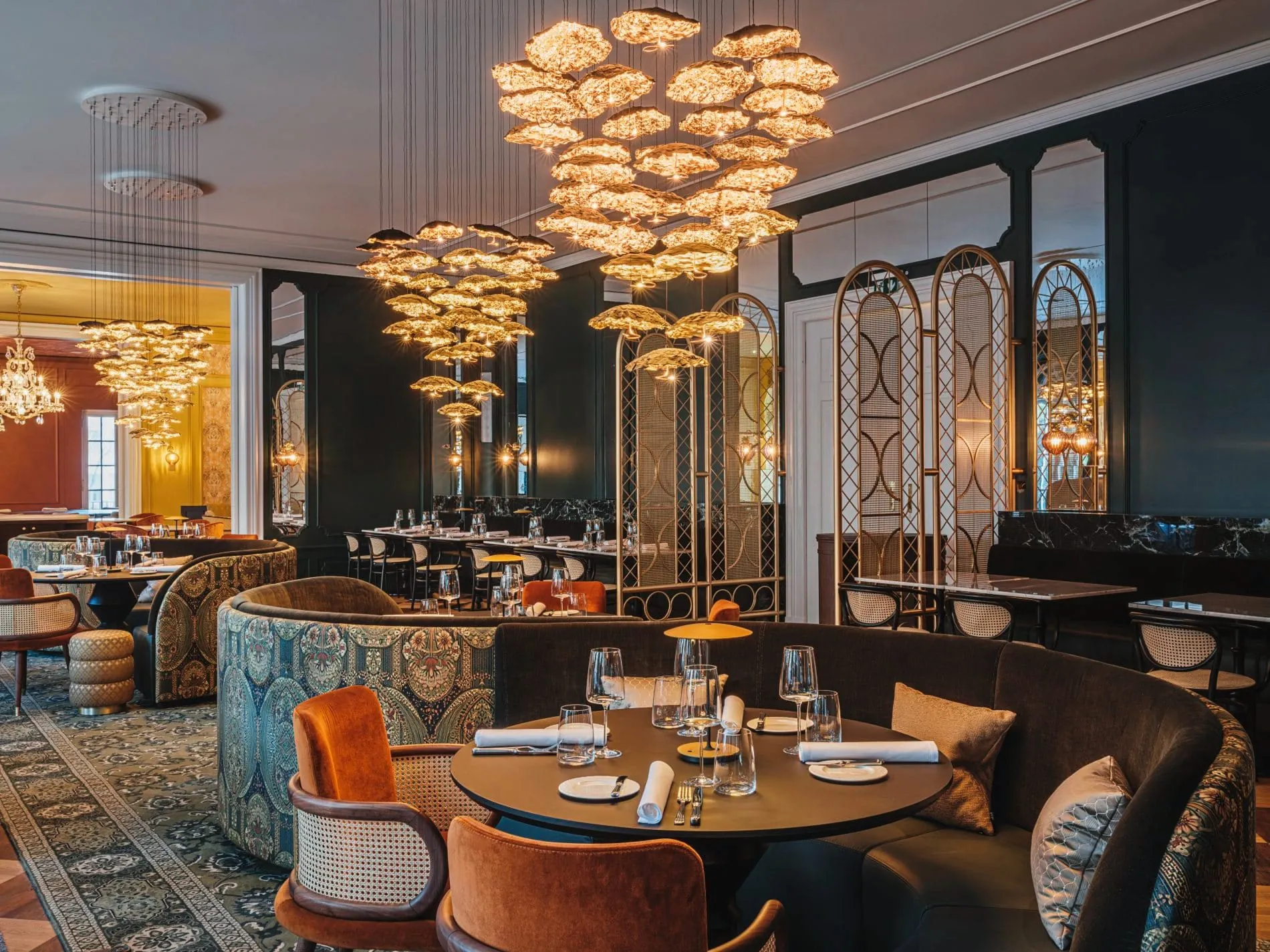 Opulente Leuchterinstallationen, samtige Polsterbänke und Paravents im indischen Stil prägen die Bombay Brasserie. Das kulinarische Herzstück bietet 60 Plätze im Innenbereich.